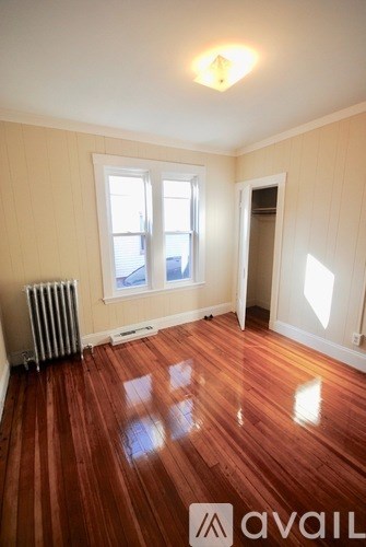 A room with wooden floors and a window.
