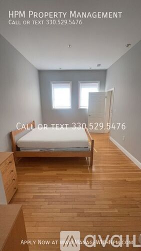 A bedroom with a bed, dresser, and window.