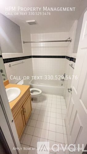 A bathroom with a toilet, sink, and shower.