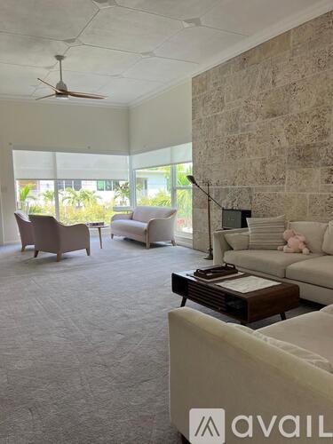A living room with a sofa, armchair, and coffee table.
