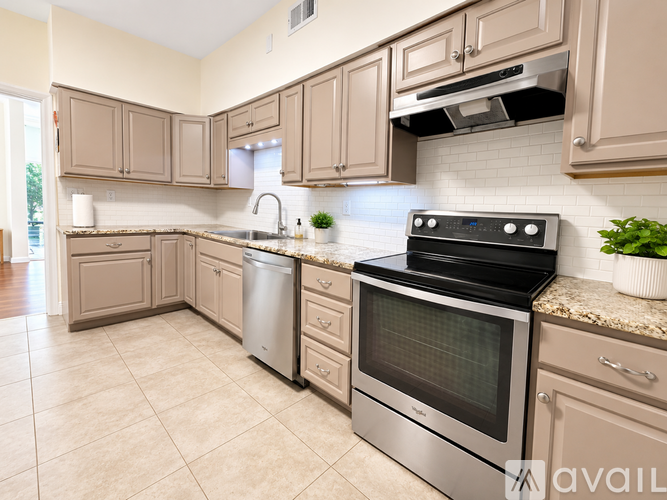 A kitchen with a stove, oven, and sink.
