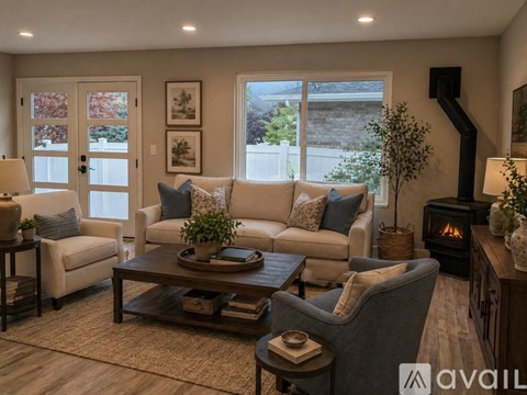 A living room with a couch, chair, and a fireplace.