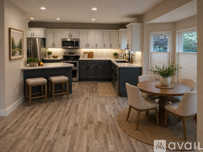A kitchen with a table and chairs in front of it.