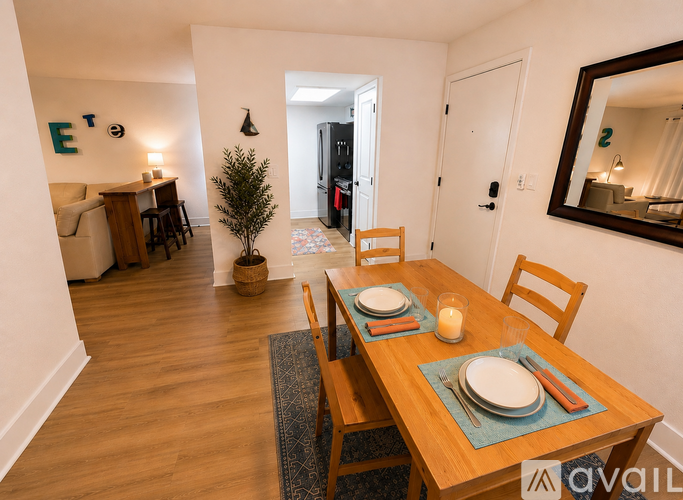 A dining room with a table set for two.