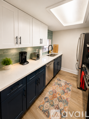 A kitchen with dark blue cabinets and a white countertop.