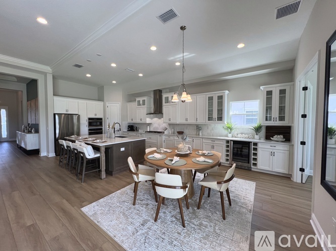 A modern kitchen with a dining table set for four.