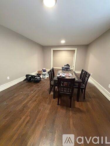 A dining room with a table set for six people.