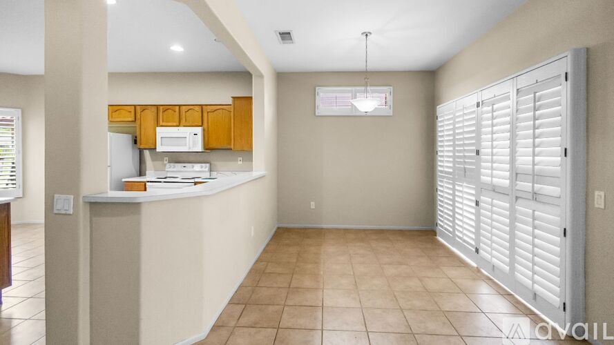 A kitchen area with a counter and cabinets.
