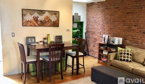 A living room with a dining table and chairs.