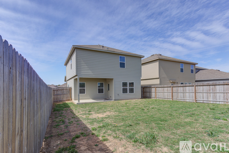 A house with a fence in front of it is for sale.