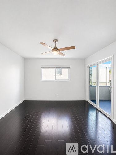 A room with a ceiling fan and a window.