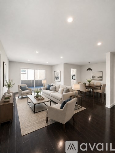A living room with a white couch and a glass coffee table.