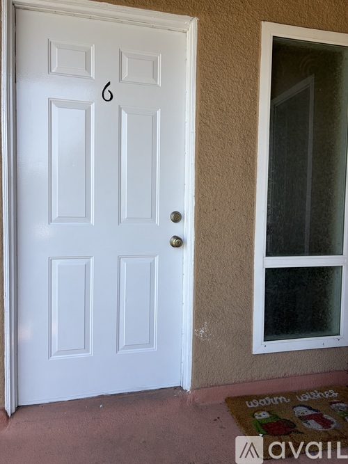 A white door with a glass window to the right.