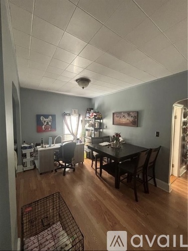 A kitchen with a dining table and chairs.