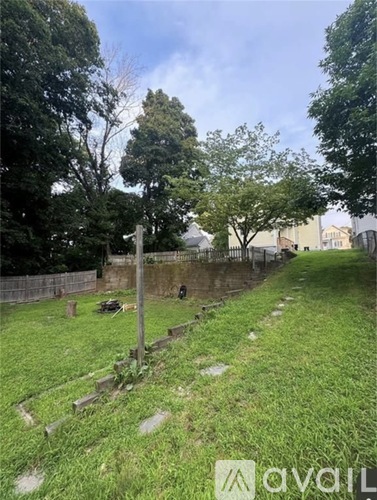 A cemetery with a grassy area and a fence.