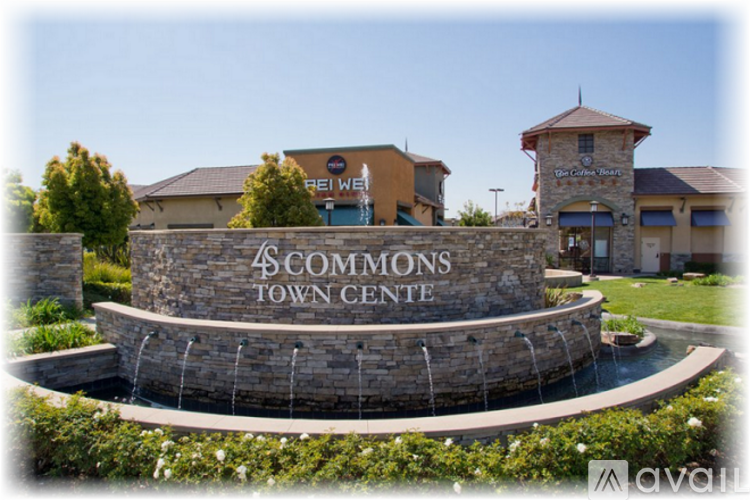 A stone wall with a sign that says 4 Commons Town Centre.