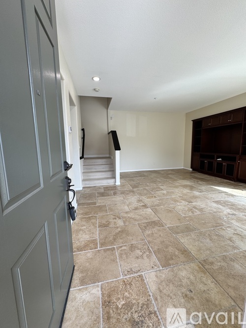 A room with a tiled floor and a closed door.