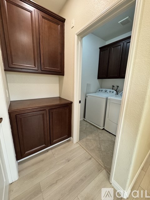 A kitchen with brown cabinets and a white stove top oven.