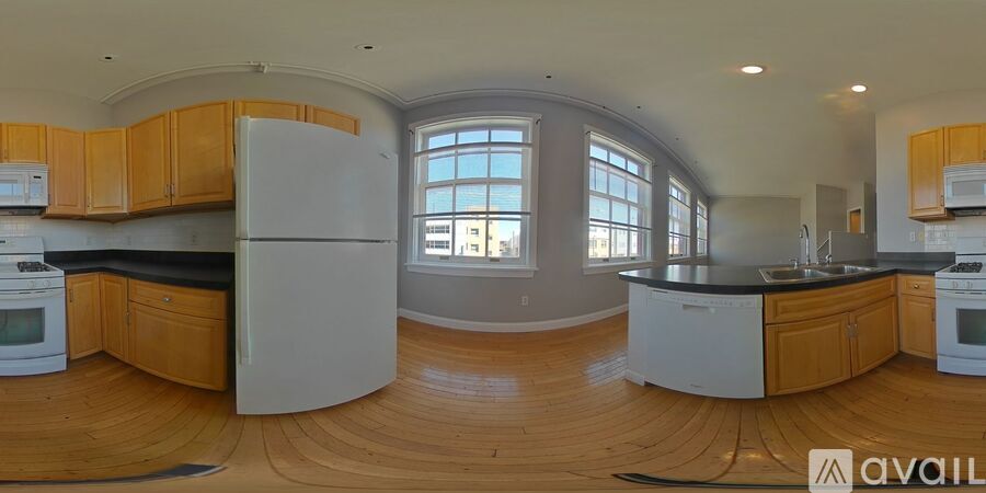A kitchen with wooden cabinets and a white refrigerator.