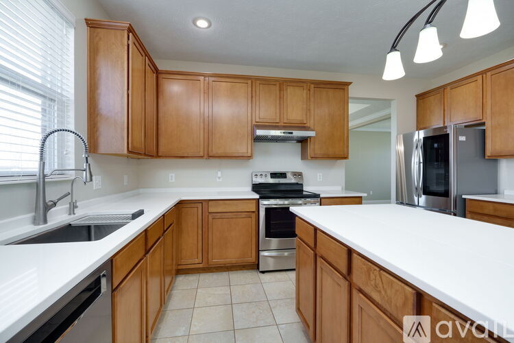 A kitchen with wooden cabinets and stainless steel appliances.