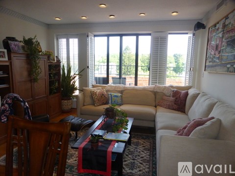 A living room with a couch, chair, and table.