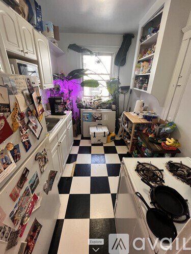 A kitchen with a black and white checkered floor.