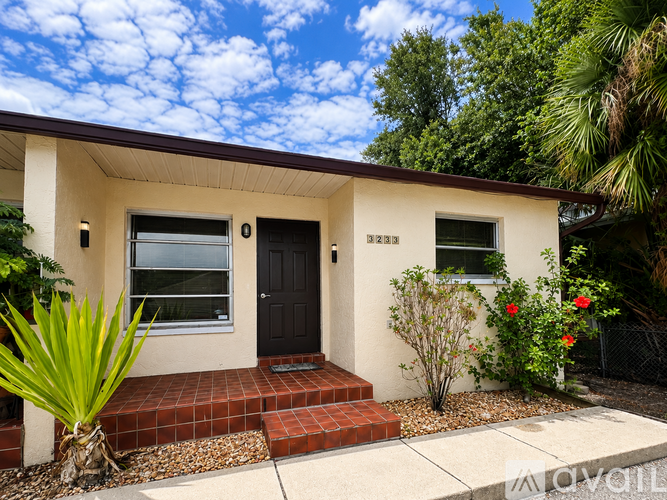 A house with a black front door and a brick step.