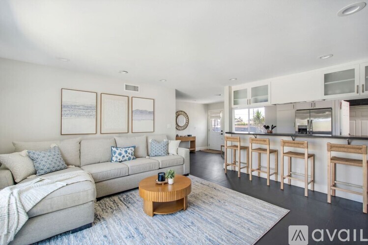 A living room with a grey couch and a coffee table.