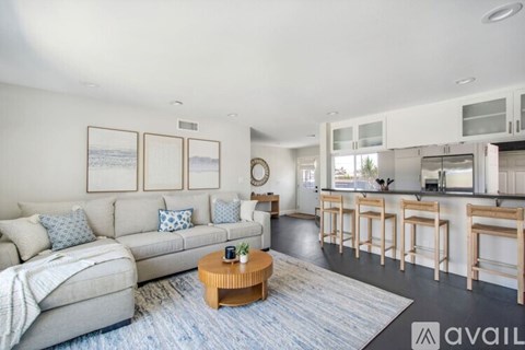 A living room with a grey couch and a coffee table.