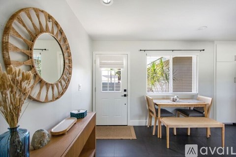A modern dining room with a wooden table and chairs.