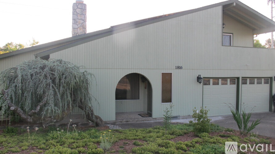 A house with a garage and a chimney is available for sale.