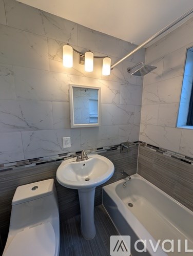 A bathroom with a sink, toilet, and bathtub.