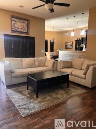 A living room with a white couch and a coffee table.