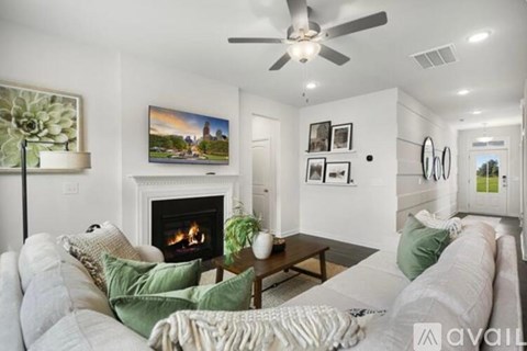 A living room with a fireplace and a painting on the wall.