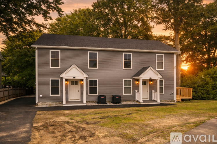 A house with a front yard and a driveway is available for sale.