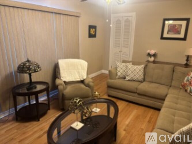 A living room with a couch, chair, and coffee table.