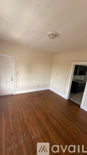 A room with wooden floors and white walls.