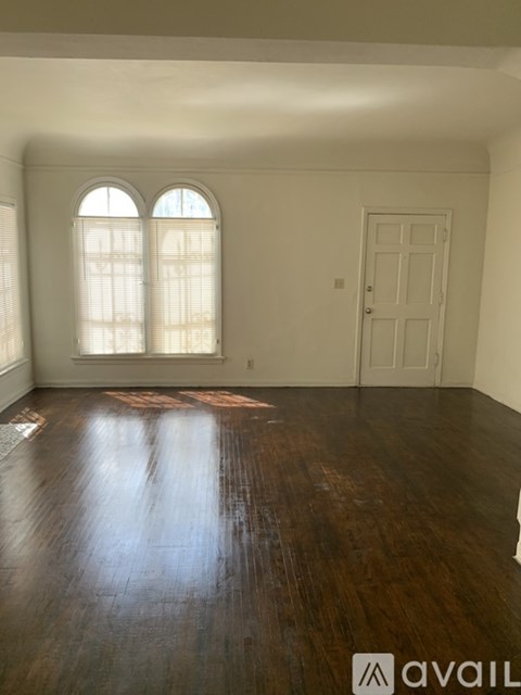 A room with wooden floors and a white door.