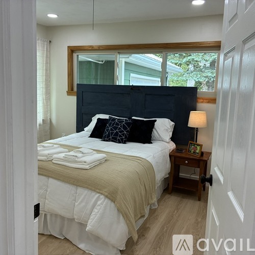 A bedroom with a large bed and a window.