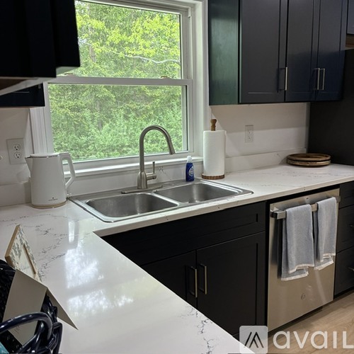 A kitchen with a sink and a window.