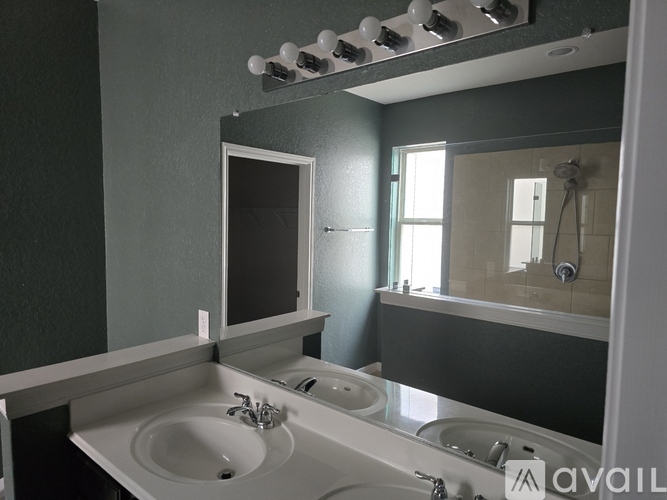 A bathroom with a sink and mirror.