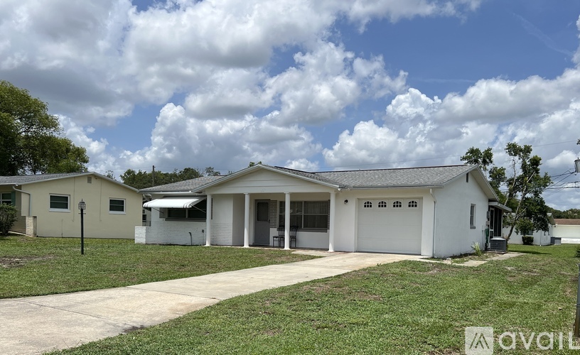 A two-story house with a garage is for sale.