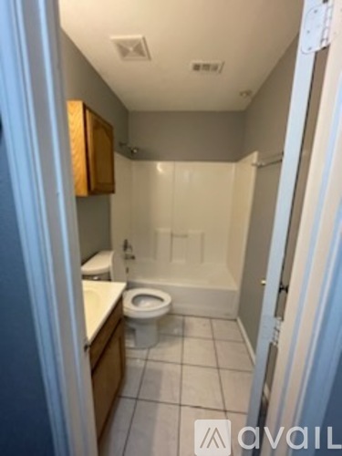 A bathroom with a toilet, sink, and shower.