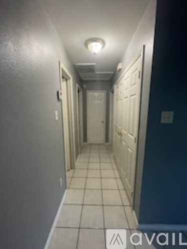 A long hallway with doors on both sides.