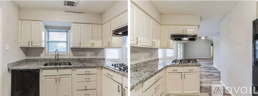 A kitchen with white cabinets and a granite countertop.