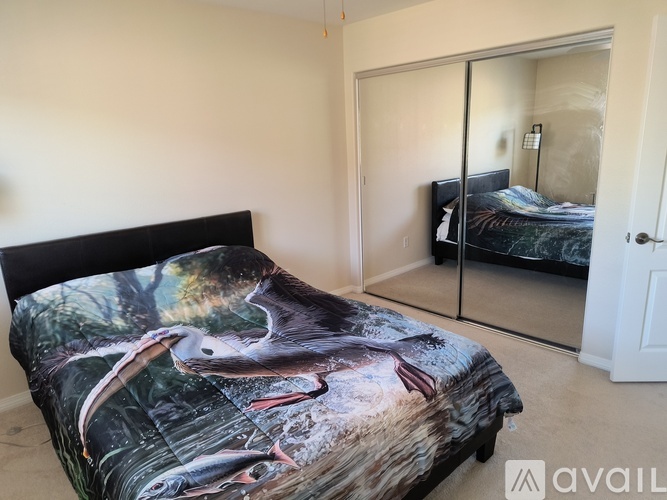 A bedroom with a bed and a wardrobe.
