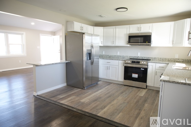 A kitchen with a refrigerator, oven, and microwave.