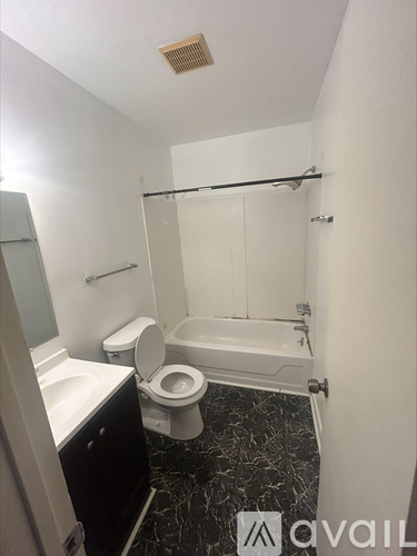 A bathroom with a toilet, sink, and bathtub.