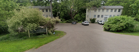 A sign that says "Countrylane" is on the side of a road.