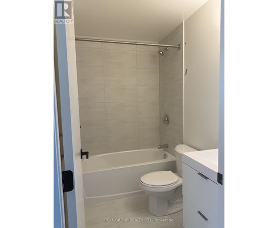 A bathroom with a toilet, sink and bathtub.